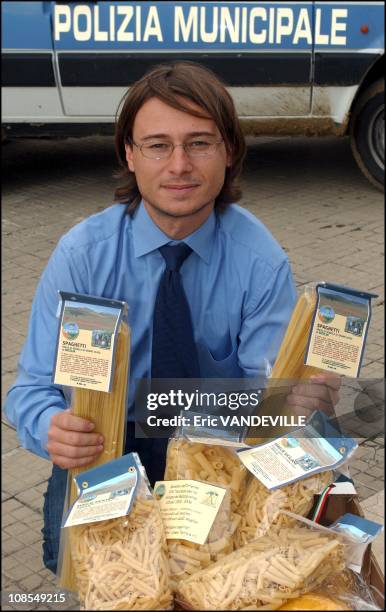 Gianluca Faraone, President of the Association "Libera" at San Giuseppe Jato near Palermo, with pasta made from wheat grown on the lands seized from...
