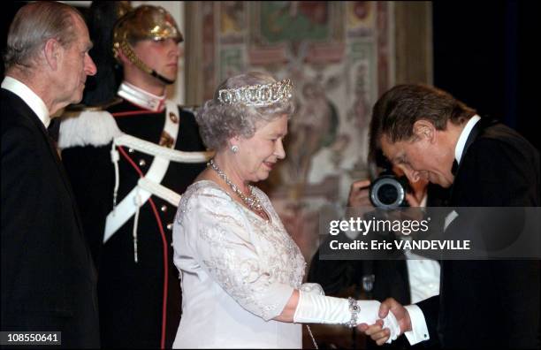 Britain's Queen Elizabeth together with Prince Philip shakes hands with fashion designer Valentino at Quirinal presidential palace before the state...