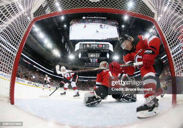 Sami Vatanen of the New Jersey Devils blocks a shot by Brady Tkachuk of the Ottawa Senators during the second period at the Prudential Center on...