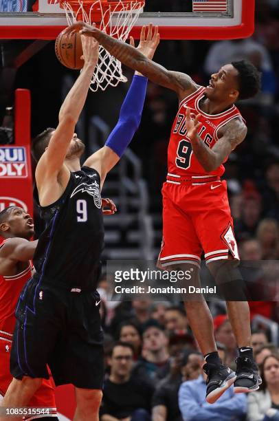 Antonio Blakeney of the Chicago Bulls leaps to knock the ball away from Nikola Vucevic of the Orlando Magic at United Center on December 21, 2018 in...