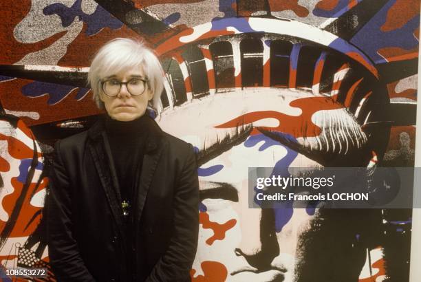 Andy Warhol standing in front of his painting of the Statue of Liberty in Paris, France on April 22nd, 1986.