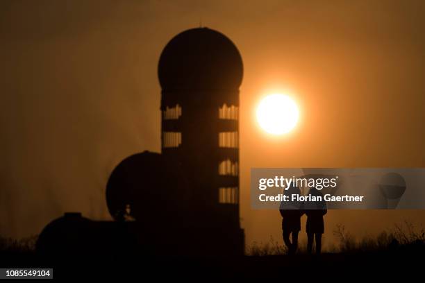 Couple is pictured in front of the former U.S. Listening station on 'Teufelsberg' at sunset on January 20, 2019 in Berlin, Germany.