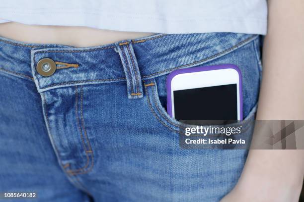woman with smart phone in jeans pocket - pocket stock pictures, royalty-free photos & images