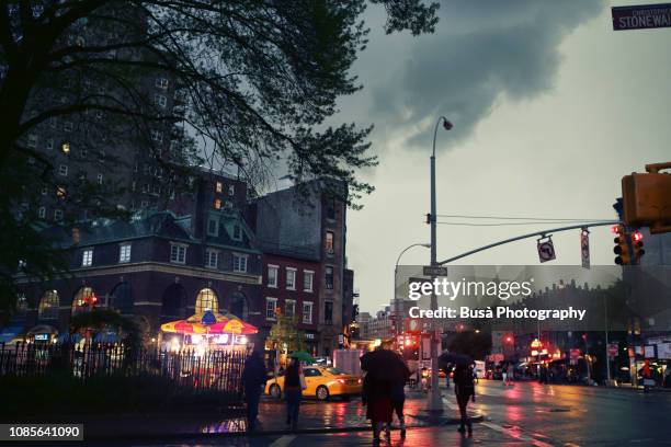 rainstorm at sheridan square, in the west village, manhattan, new york city - west village stock pictures, royalty-free photos & images