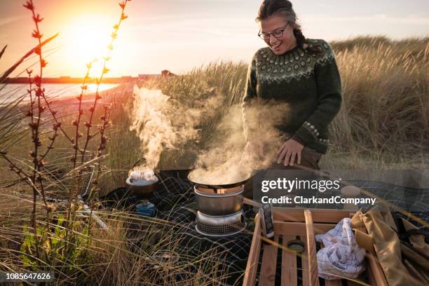 fisherman cooking her catch at the beach - beach denmark stock pictures, royalty-free photos & images