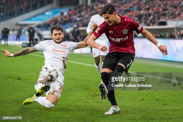 Matthias Zimmermann of Düsseldorf challenges for the ball with Miiko Albornoz of Hannover during the Bundesliga match between Hannover 96 and Fortuna...