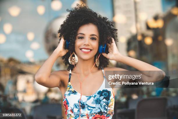 portrait of young woman with blue headphones - girl gold dress stock pictures, royalty-free photos & images