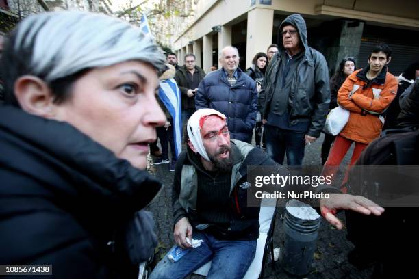 Photojournalist seriously injured after protesters attacked him. Protesters clash with riot police during a demonstration in Syntagma square against...