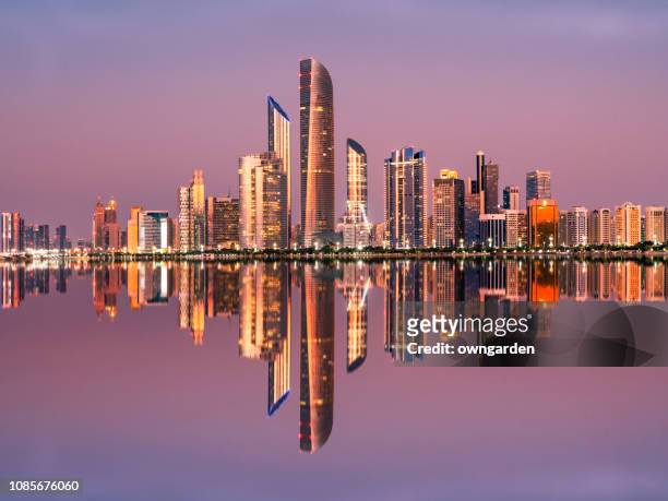 abu dhabi city skyline at twilight, united arab emirates - abu dhabi stock pictures, royalty-free photos & images
