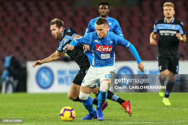 Lazio's Bosnian midfielder Senad Lulic and Napoli's Polish midfielder Piotr Zielinski go for the ball during the Italian Serie A football match...