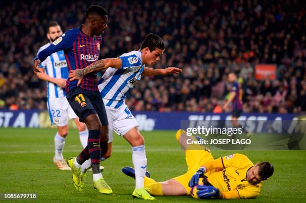 Barcelona's French forward Ousmane Dembele vies with Leganes' Argentinian defender Jonathan Silva and Leganes' Spanish goalkeeper Pichu Cuellar...