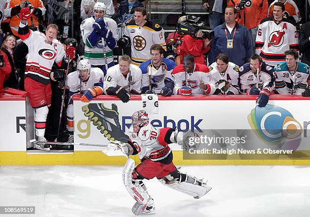 The Carolina Hurricanes' Eric Staal, left, a team captain for the NHL All-Star Game, cheers on his teammate Cam Ward as Ward skates to a win in the...