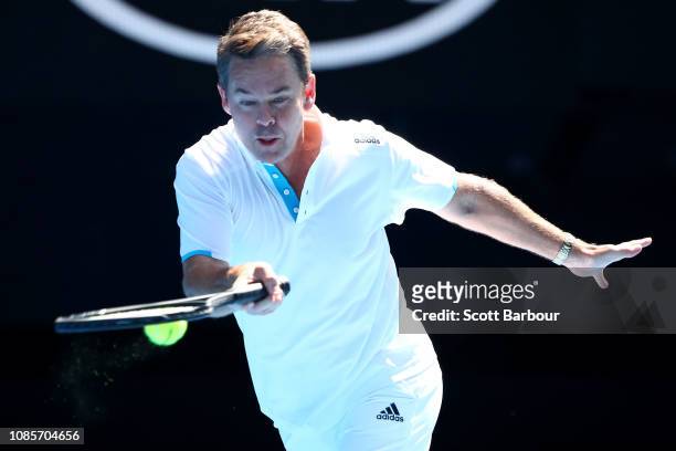 Todd Woodbridge of Australia plays a forehand in his Men's Legends match against John McEnroe and Patrick McEnroe of the United States during day...