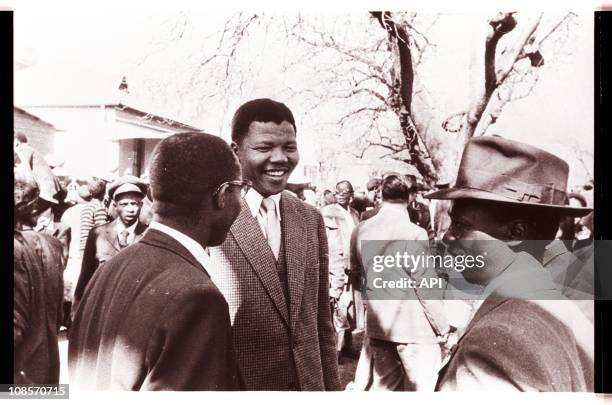 Mandela speaking with codefendants outside the "Treason Trial" late 1950's in South Africa.