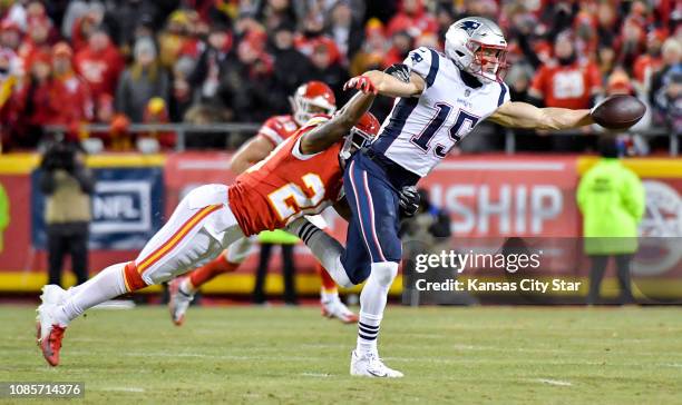 New England Patriots wide receiver Chris Hogan pulls in a pass from quarterback Tom Brady despite defensive pressure by Kansas City Chiefs cornerback...