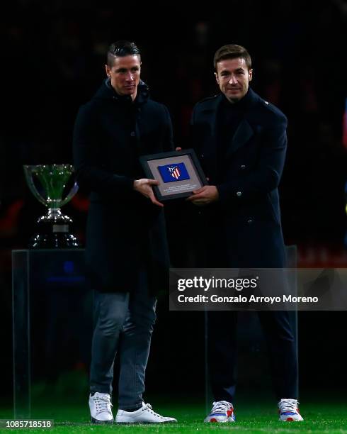 Former Atletico de Madrid players Fernando Torres and Gabi Fernandez attend a tribute in honor of the second after the La Liga match between Club...