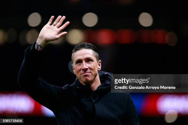 Former Atletico de Madrid player Fernando Torres waves the audience as he attends a tribute in honor of his former teammate Gabi Fernandez after the...