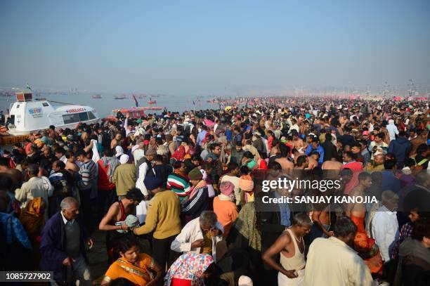 Indian Hindu devotees gather at Sangam, the confluence of the rivers Ganges and Yamuna and mythical Saraswati, on the event of the holy day Paush...