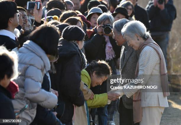 Japan's Emperor Akihito and Empress Michiko meet well-wishers as they stroll on a beach near the Hayama Imperial Villa in Hayama, Kanagawa Prefecture...