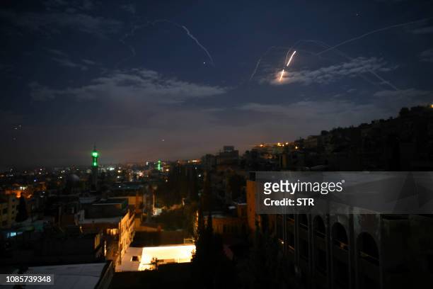 Picture taken early on January 21, 2019 shows Syrian air defence batteries responding to what the Syrian state media said were Israeli missiles...