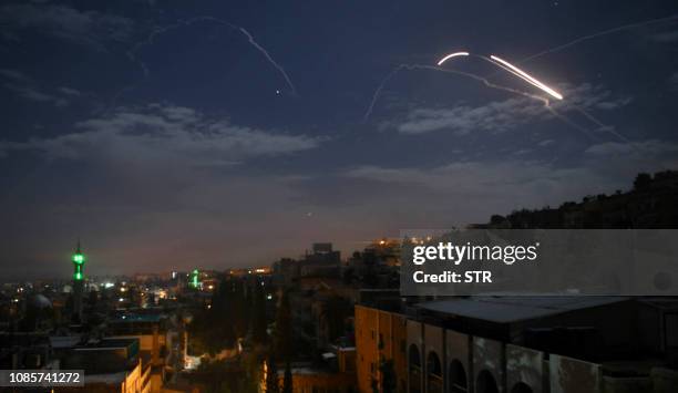 Picture taken early on January 21, 2019 shows Syrian air defence batteries responding to what the Syrian state media said were Israeli missiles...