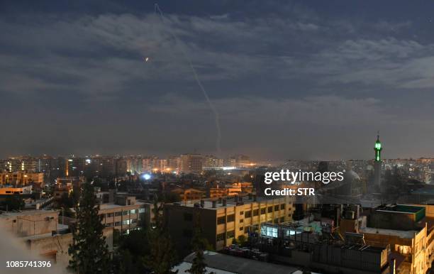 Picture taken early on January 21, 2019 shows Syrian air defence batteries responding to what the Syrian state media said were Israeli missiles...