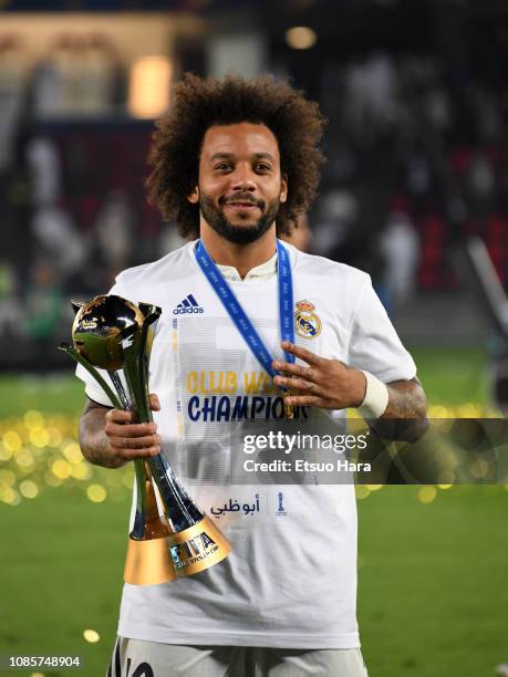 Marcelo of Real Madrid celebrates with the trophy after the match between Real Madrid and Al Ain on December 22, 2018 in Abu Dhabi, United Arab...