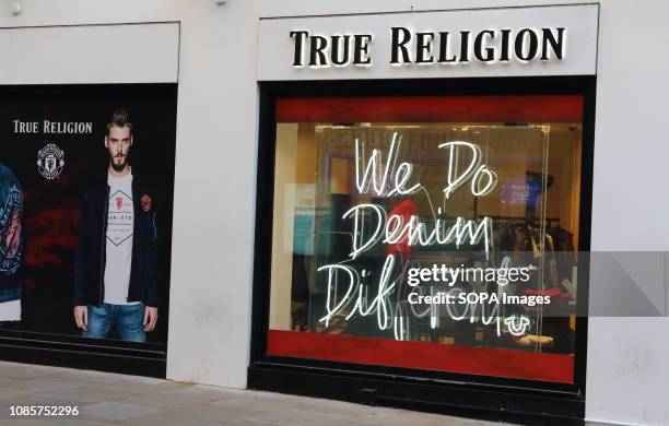 True Religion brand logo seen in Carnaby Street in London, UK.