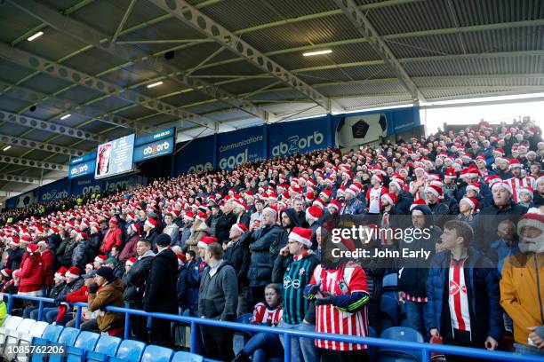 Southampton fans wear christmas hats during the Premier League match between Huddersfield Town and Southampton FC at John Smith's Stadium on December...