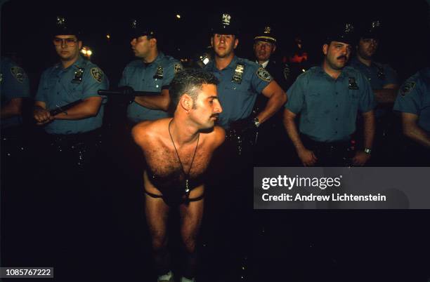 Participant of the annual gay pride celebrations shows off his skimpy clothing to members of the New York City police department in June of 1993 in...