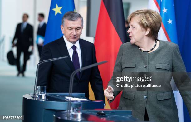 January 2019, Berlin: Federal Chancellor Angela Merkel and Shavkat Mirsijoev, President of Uzbekistan, attend a press conference before their talks...