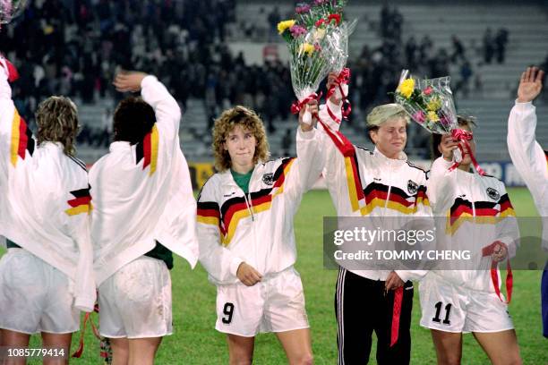 Germany's Heidi Mohr and her teamate salute the 67,000-strong audience during the medal presentation ceremony of the first FIFA World Championship...