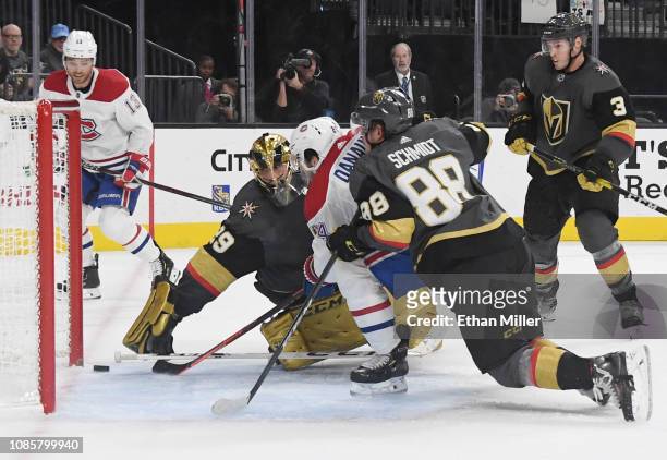 Phillip Danault of the Montreal Canadiens scores his third goal of the game against Marc-Andre Fleury and Nate Schmidt of the Vegas Golden Knights to...