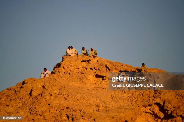 People gather on a hilltop during the 2019 AFC Asian Cup Round of 16 football match between Australia and Uzbekistan at the Khalifa bin Zayed Stadium...