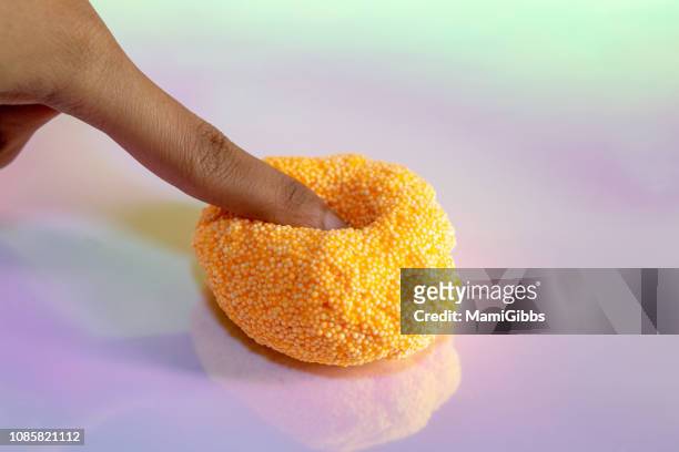 beads slime with human hand - slime stockfoto's en -beelden