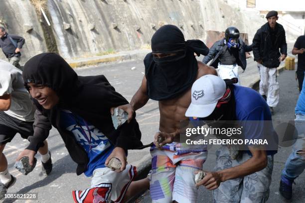 Anti-government demonstrators clash with police and troops in the surroundings of a National Guard command post in Cotiza, in northern Caracas, on...