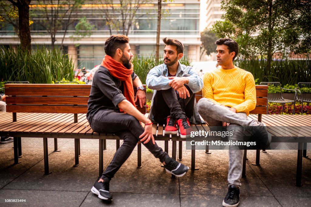 Three male friends hanging out.