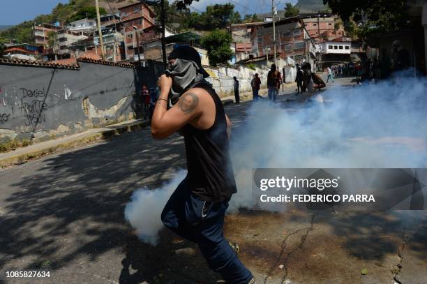 Anti-government demonstrators clash with police and troops in the surroundings of a National Guard command post in Cotiza, in northern Caracas, on...