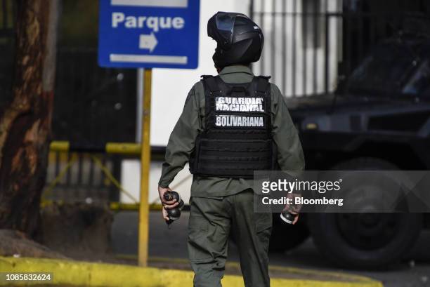 National Guard member holds tear gas canisters during a protest in the Cotiza neighborhood of Caracas, Venezuela, on Monday, Jan. 21, 2019. A number...