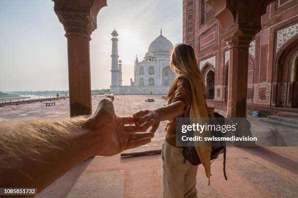 couple holding hands at the taj mahal, india - islam temple stock pictures, royalty-free photos & images