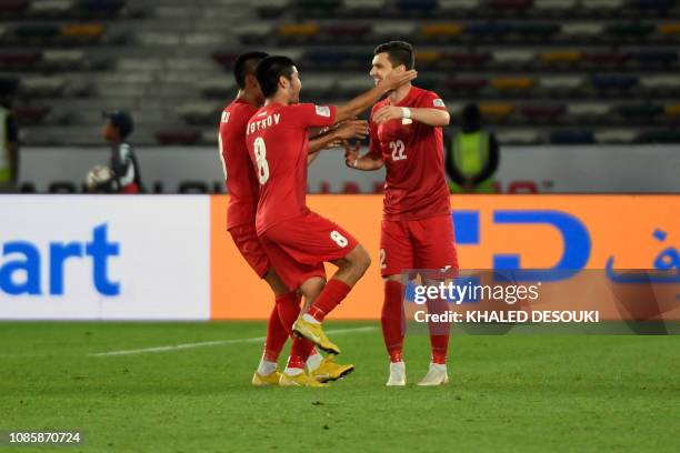 Kyrgyzstan's players celebrate their equalising goal during the 2019 AFC Asian Cup Round of 16 football match between UAE and Kyrgyzstan at the Zayed...