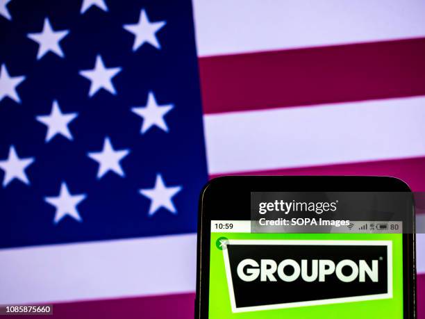 In this photo illustration, the Groupon company logo seen displayed on a smartphone.