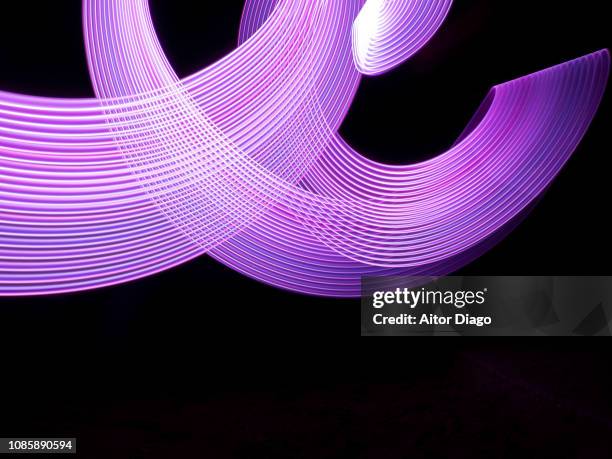purple curved lines forming a net in 3d. light painting - light at the end of the tunnel stock pictures, royalty-free photos & images