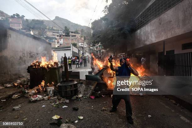 Protester is seen in front of a burning barricade during a protest against Nicolas Maduro. 27 Military officers of the National Guard were arrested...