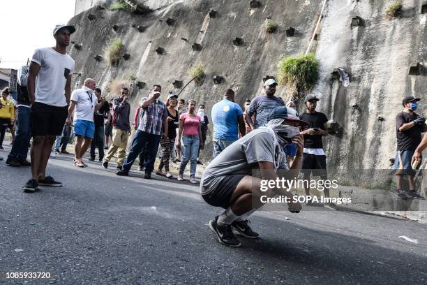 Demonstrators seen facing police during a protest against Nicolas Maduro. 27 Military officers of the National Guard were arrested after revolting in...