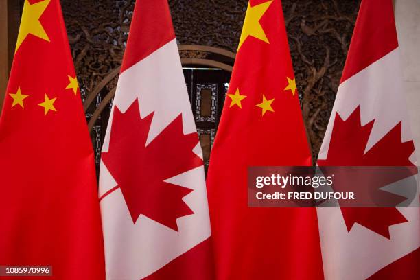 This picture taken on December 5 shows Canadian and Chinese flags taken prior to a meeting with Canada's Prime Minister Justin Trudeau and China's...