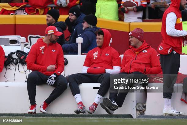 Kansas City Chiefs quarterbacks Patrick Mahomes and Chad Henne sit with quarterbacks coach Mike Kafka on the bench before the AFC Championship Game...