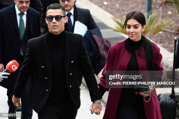 Juventus' forward and former Real Madrid player Cristiano Ronaldo arrives with his Spanish girlfriend Georgina Rodriguez to attend a court hearing...