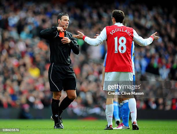 Sebastien Squillaci of Arsenal reacts as he is shown a straight red card by Referee Mark Clattenburg after his foul on Jack Hunt of Huddersfield...