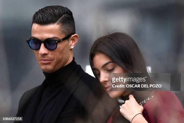 Juventus' forward and former Real Madrid player Cristiano Ronaldo leaves with his Spanish girlfriend Georgina Rodriguez after attending a court...